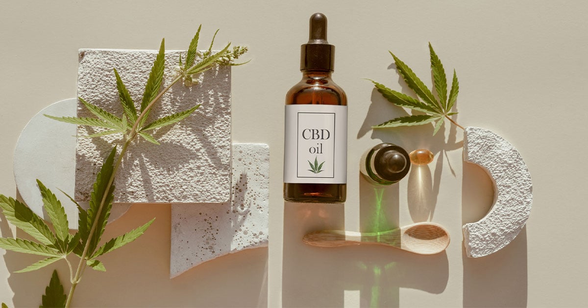 bottle of cbd next to white stone