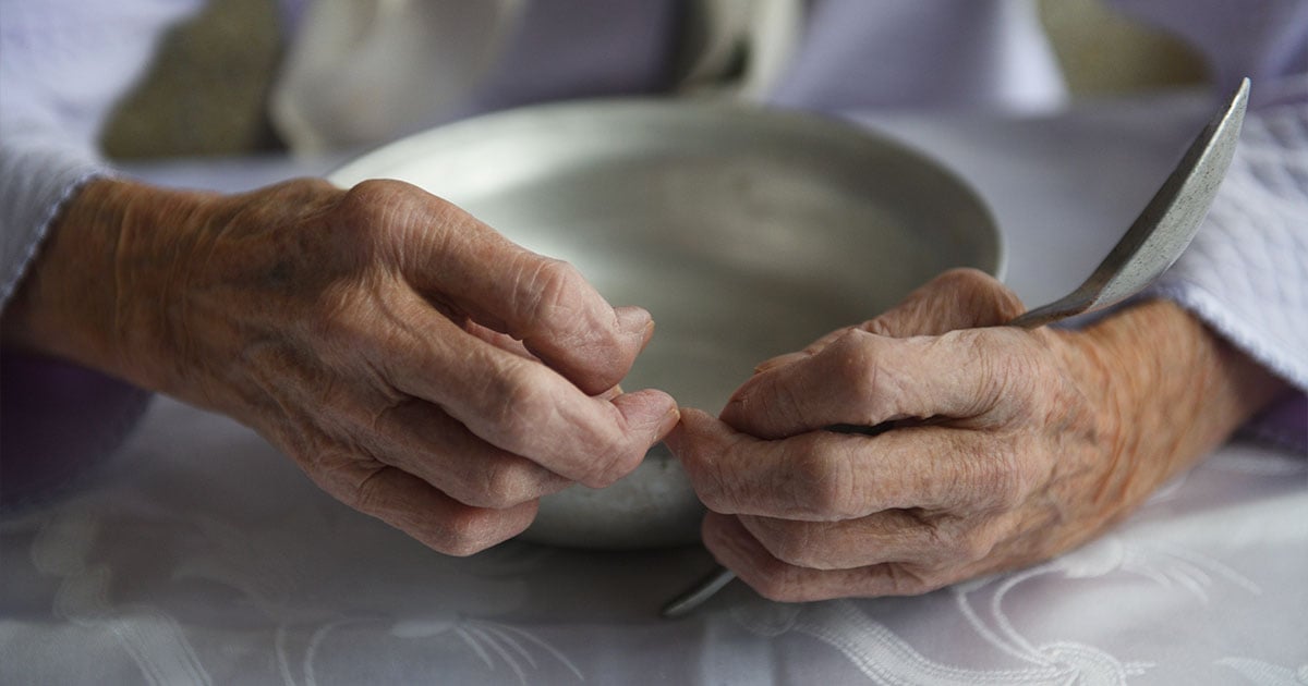 grandmother holding bowl and spoon