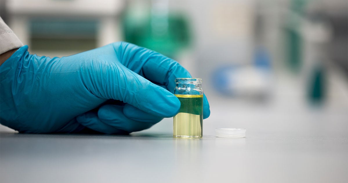 lab tech holding vial of cbd oil