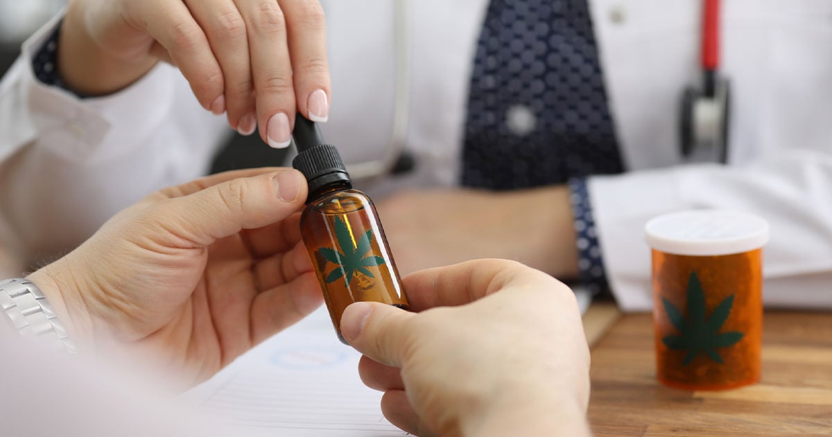 Doctor with tincture bottle of cbd